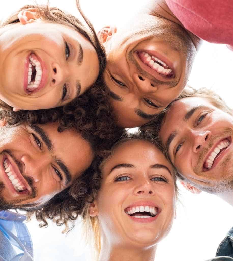 Smiling person showcasing white teeth after laser whitening treatment Reading